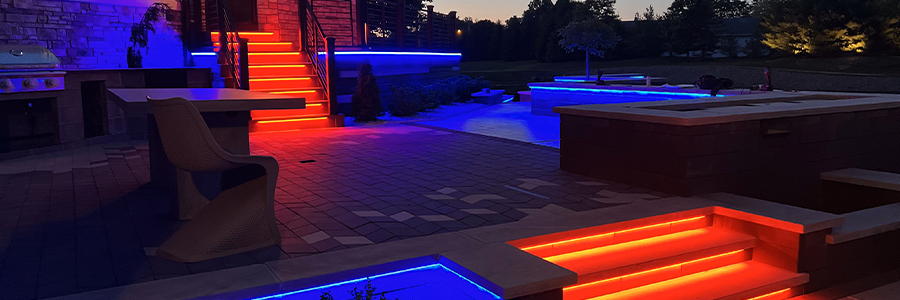 backyard lit by RGB blue and red lights hero Modern backyard lit by blue and red RGB lights