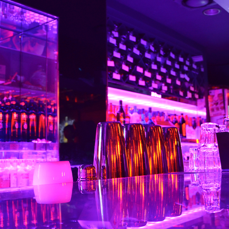 bar-counter-illuminated-by-led-black-light-strips modern bar illuminated by black light