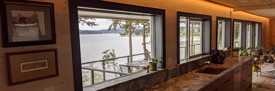 Kitchen interior with panoramic water views and ambient ceiling lighting