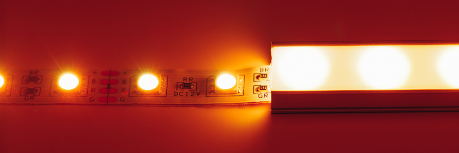 led-strip-light-closeup-with-diffuser-cover Close-up of an LED strip light with a diffuser cover, emitting warm orange light