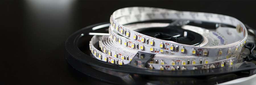 led-strip-lighting-roll A roll of flexible LED strip lighting with small, densely packed LED lights.