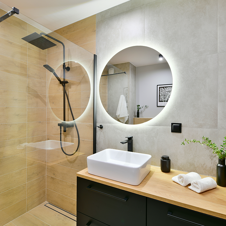 Minimalist bathroom design with illuminated mirror and rain shower