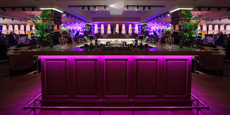RGB-led-strips-under-the-bar-counter bar counter lightened by pink lights mande with RGB light strips.