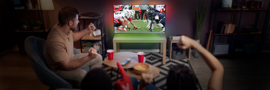 friends-watching-with-a-football-game-image-and-back-lights Group of friends watching a football game on a large flat-screen television, complemented by LED backlighting and minimalist furniture.