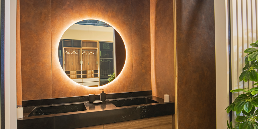 Backlighted circular mirror Warm backlighting for a circular mirror over the vanity